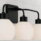 Capital Lighting Tanner 24.5''w X 9.75''h 3-light Vanity In Matte Black With Soft White Glass Globes